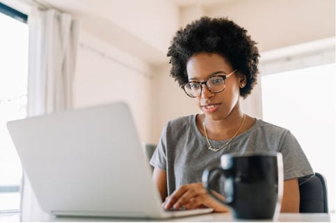 Woman uses a laptop to check her rate for a personal loan with a soft credit pull